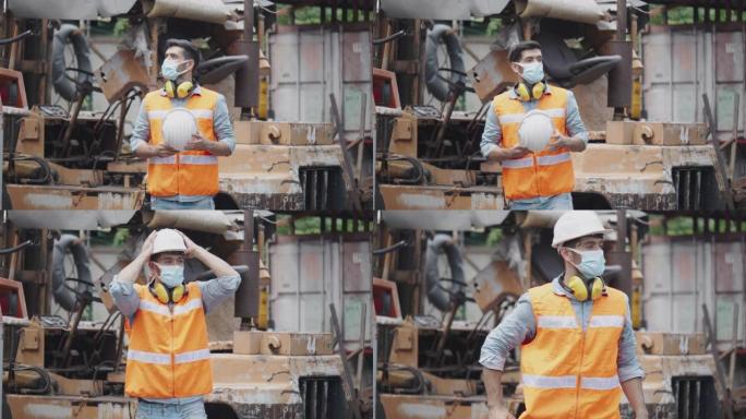 工程师或建筑工人在工作场所佩戴安全设备，如安全帽、口罩、耳机，以防止行业发生事故。面罩灰尘和冠状病毒