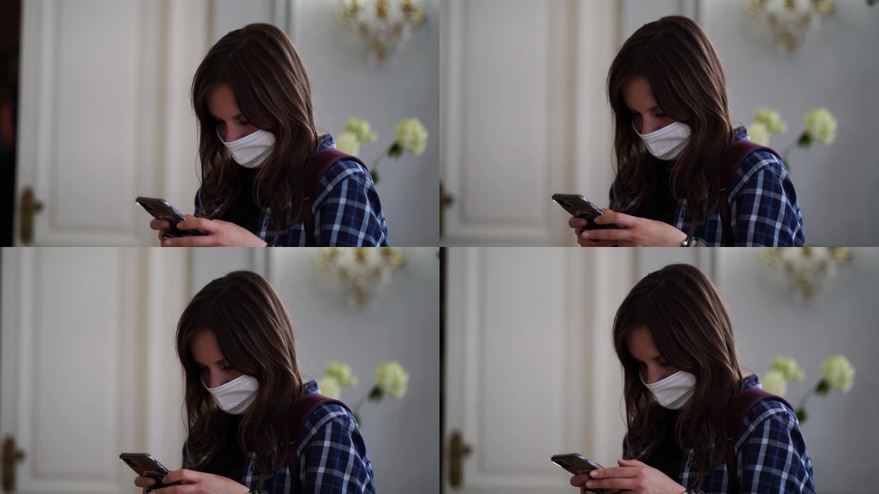 戴着医用口罩的年轻女子的特写镜头在智能手机上翻转新闻。双手拿着手机的成年女性肖像