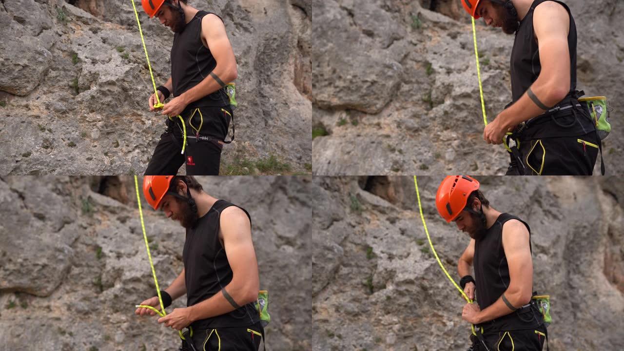 自由登山者在攀岩前固定绳索