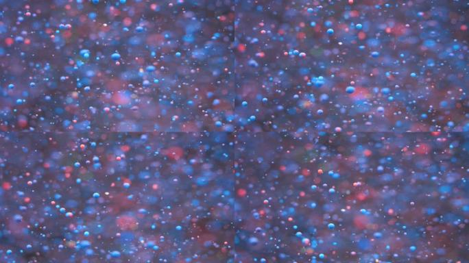霓虹泡泡油美丽的油漆宇宙颜色移动五彩。假日背景。圣诞节。星系星云太空恒星行星。蓝色霓虹灯。具有混沌运