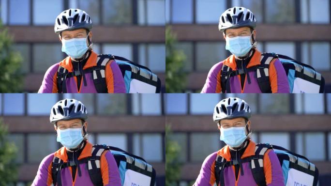 戴着医用口罩和自行车头盔的女快递员肖像