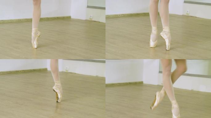 在工作室里，女芭蕾舞演员的脚在脚尖上跳舞。4K