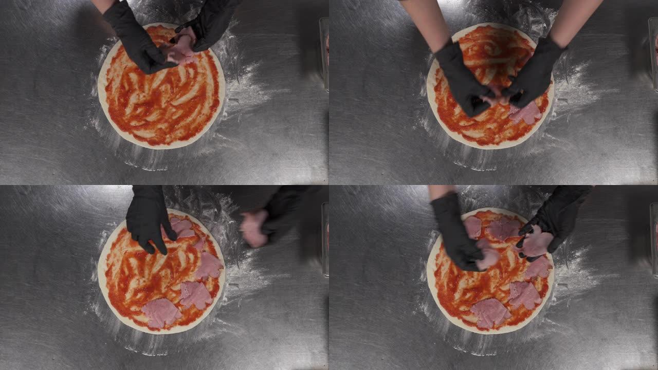 在餐馆准备意大利披萨。厨师的俯视图将培根和酱汁放在面团上