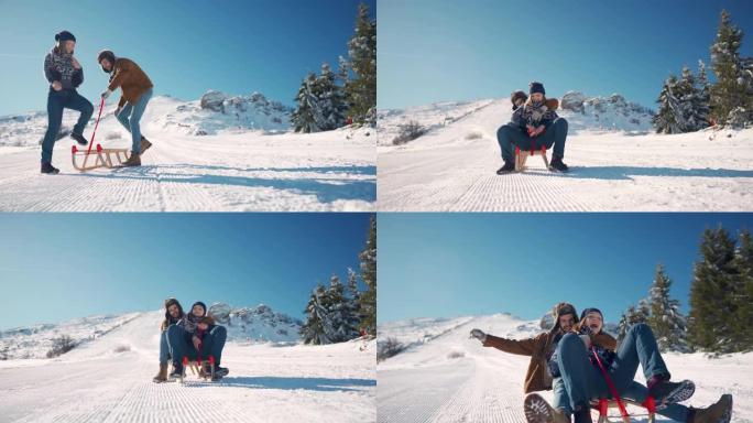微笑的年轻夫妇一起坐在雪山上