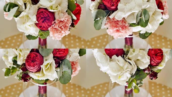 婚礼花束的绣球花，介子形玫瑰，康乃馨和桉树绿色。旋转花束