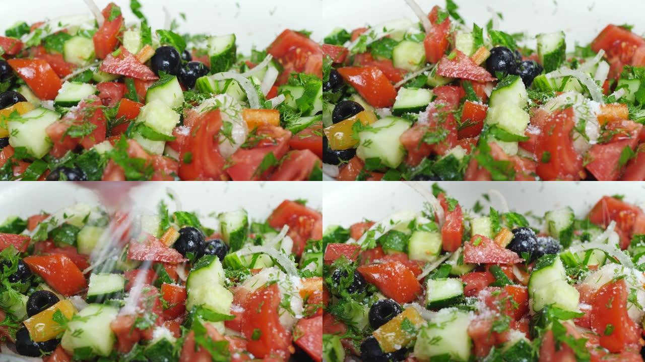 盐混合沙拉配新鲜红番茄、青黄瓜、洋葱和橄榄