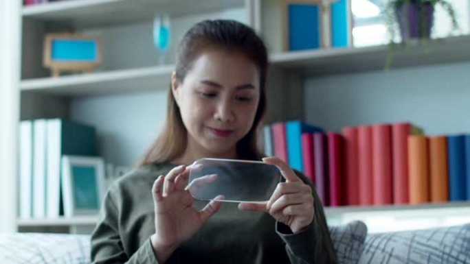 年轻女子在智能手机上使用高科技隐形全息虚拟