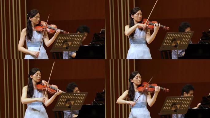 音乐家在古典音乐会上演奏小提琴和钢琴