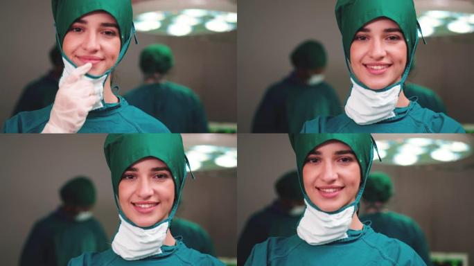 微笑的女医生的肖像对她的工作感到满意，并以医院手术室为背景。医学、技术、保健和人民、医院的概念