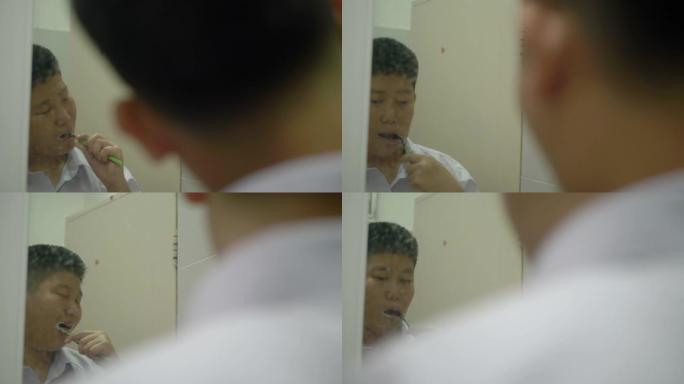 穿着制服的亚洲男生早上上学前刷牙，生活方式观念。