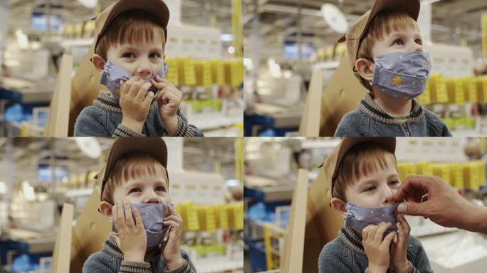 大流行期间，小男孩试图在一家购物中心脱下防护口罩