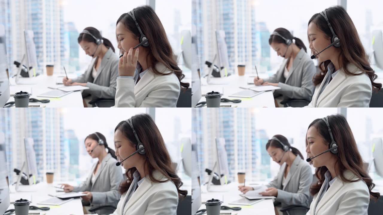 漂亮微笑的亚洲女性在城市办公室的电话中担任客户服务代理
