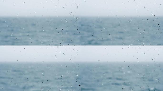 阿根廷巴里洛切的窗户上的雨，背景是暴风雨的湖