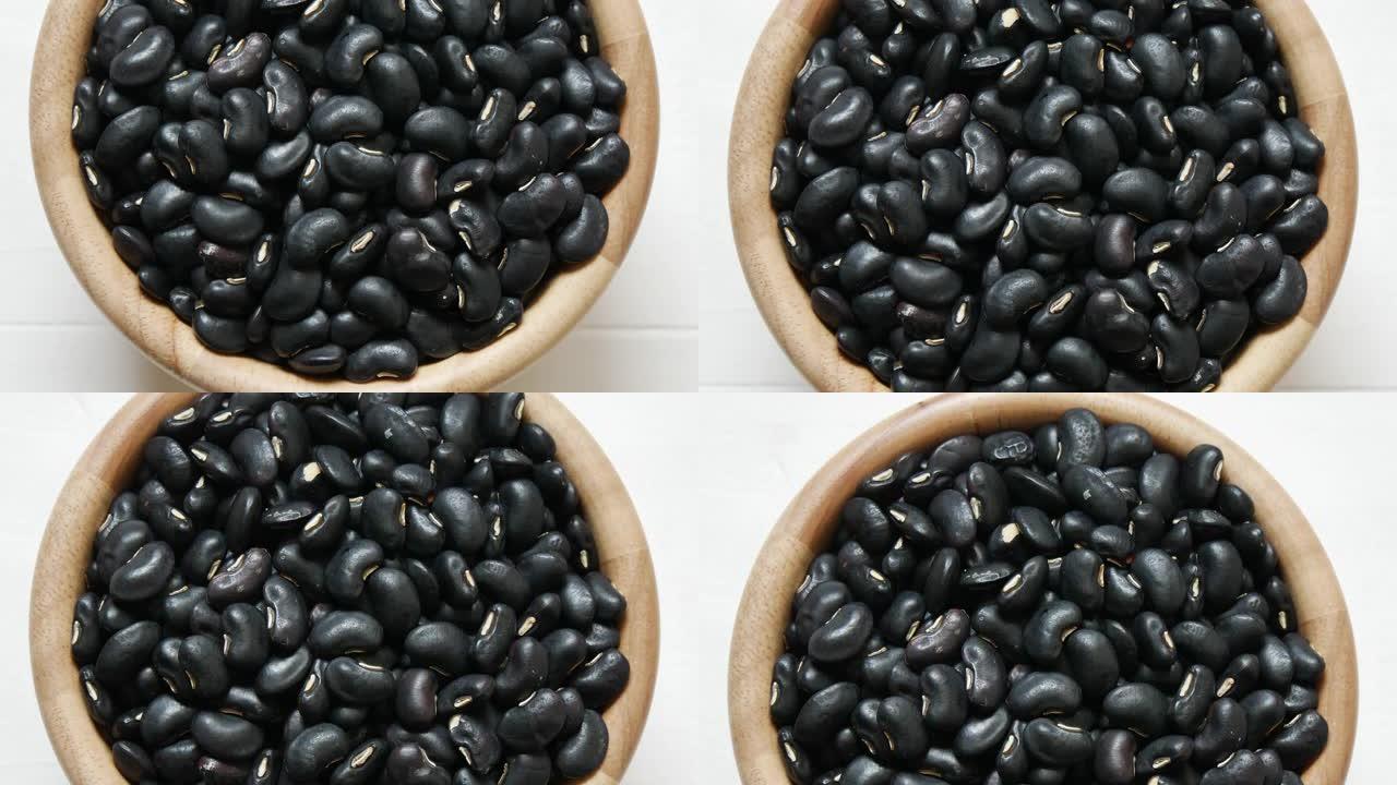 生黑豆种子食品有机俯视图质地，富含钙，有助于维护骨骼和牙齿，补充食品，蛋白质健康食品，视频录像。