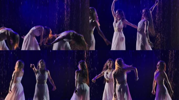 三个穿着白色长裙的女人在冒烟的背景下在雨中与玫瑰共舞。慢动作。特写