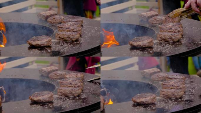 慢动作: 厨师用热火焰在火盆上烤汉堡肉排
