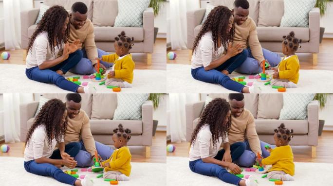 一个非洲家庭在家里和小女儿玩耍