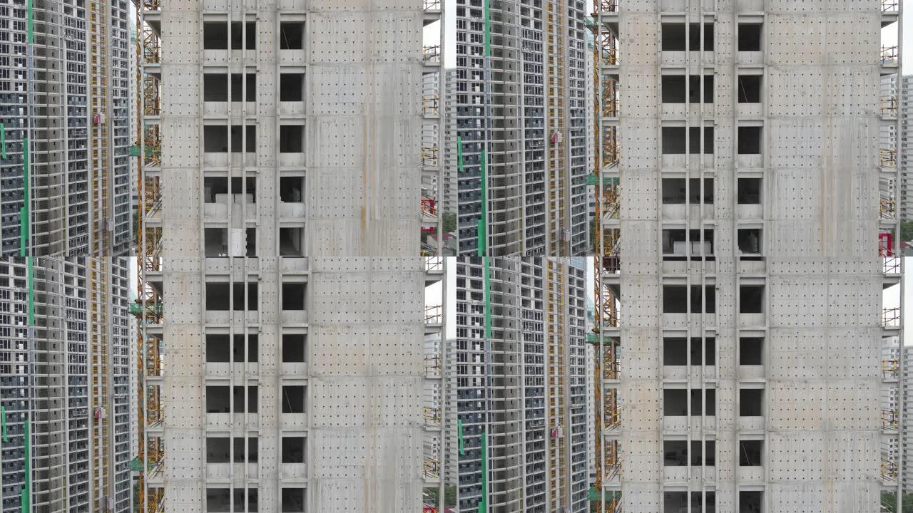 鸟瞰图无人机在建筑工地史诗般的工作场所的摩天大楼周围飞行