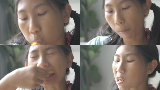 快乐的亚洲女孩在家吃黄油奶油零食，生活方式理念。