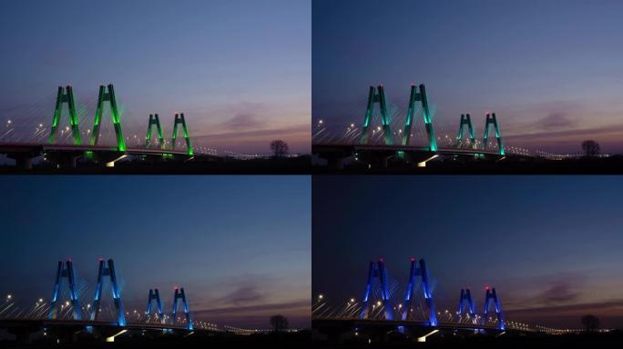 日落时，波兰克拉科夫维斯瓦河上具有纪念意义的，照明的新型现代双斜拉桥，延时，超流视频。