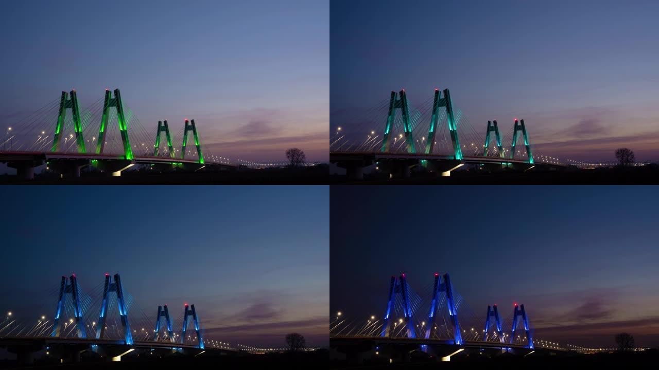 日落时，波兰克拉科夫维斯瓦河上具有纪念意义的，照明的新型现代双斜拉桥，延时，超流视频。