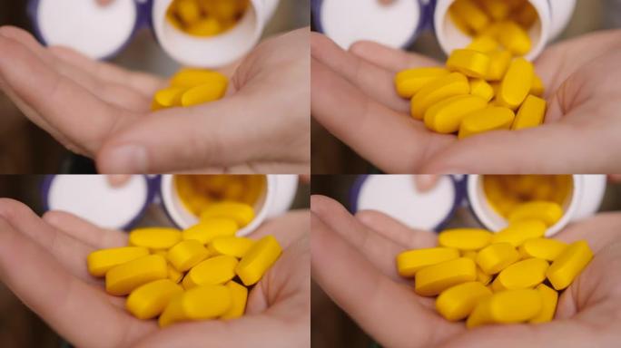 维生素和补充剂。手握各种黄色药丸。慢动作。药物片剂，胶囊从手。抗抑郁药，头痛，抗生素，心脏病发作。