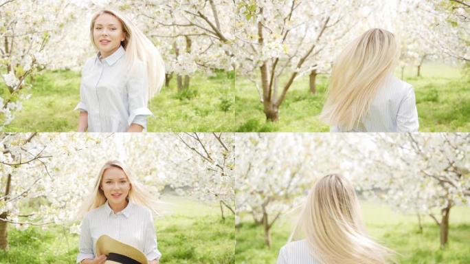 美丽的金发女郎跑过盛开的樱桃花园。