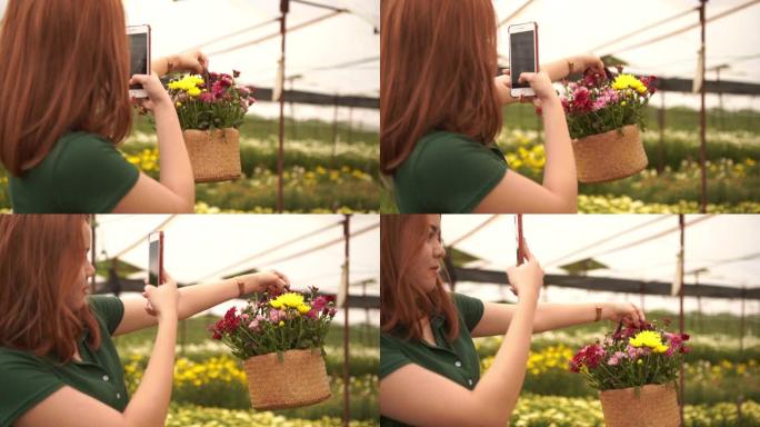 女人用手机自拍，手里拿着野花复古柳条篮