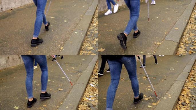 用棍子在人行道上行走的盲人特写。残障，自治，独立