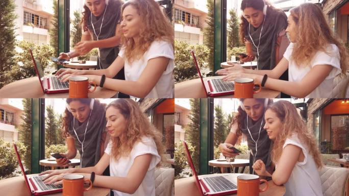 咖啡馆里的年轻女性听音乐和使用笔记本电脑