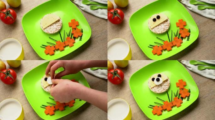 儿童健康饮食艺术小吃。盘子上的滑稽脸