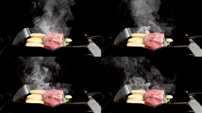 超级慢动作食物烹饪镜头。用烤架煮土豆和肉。餐厅的厨师用白烟烹饪美味的烤肉。高清