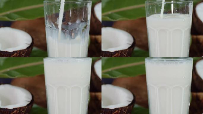 将椰奶倒入玻璃杯中。