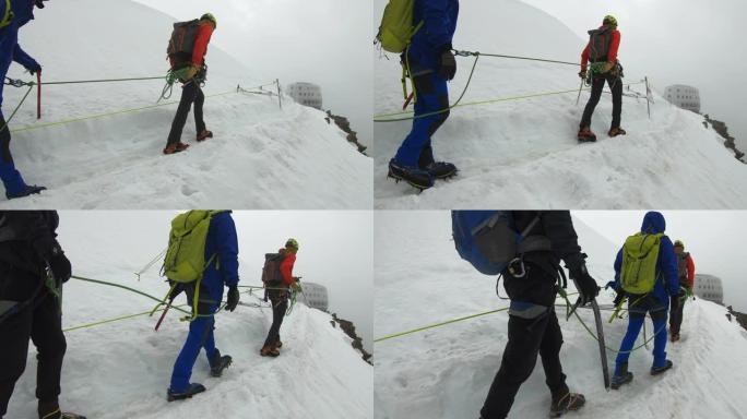 男人正在爬到山顶战胜自然挑战缆绳