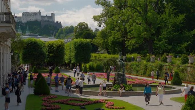 阳光明媚的夏日萨尔茨堡市著名旅游拥挤花园慢动作全景4k奥地利