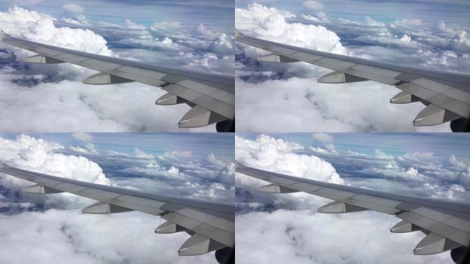 用手机拍摄，从飞机的窗户看，从飞机的窗户看，云彩和天空。4k分辨率b-roll。
