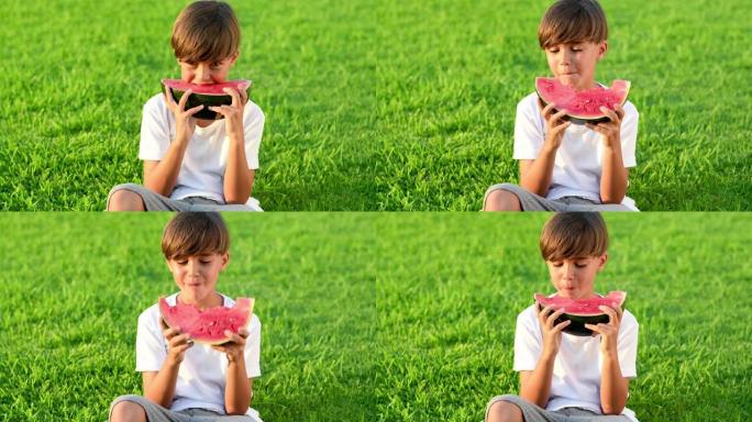 孩子吃西瓜躺在绿草背景