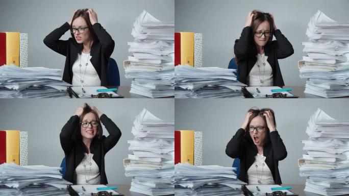 年轻的女职员在办公室里发脾气。压力和疲惫的经理撕裂她的头发和愤怒的尖叫。成堆的未完成的文件，未填写的