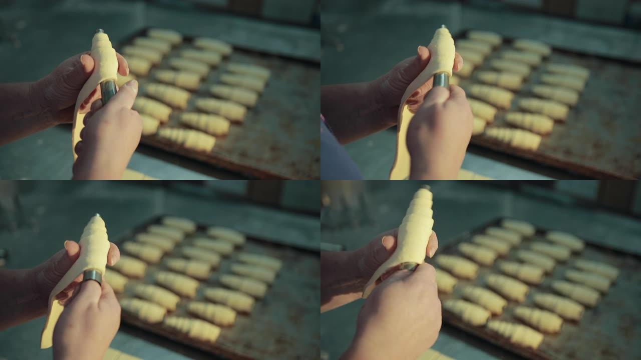 女性在烤房的厨房里制作传统的法国羊角面包。