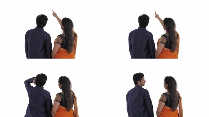 印度夫妇的背景图。女人用手指指着远处点头。男人困惑地用左手抓挠颈背。选择正确的方式。孤立在白色背景上