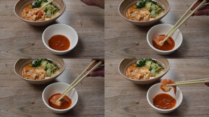用筷子采摘酱汁的汤煮海鲜寿喜烧