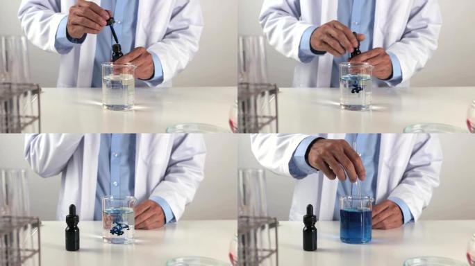 年轻的科学家男子在实验室中进行测试时掉落并搅拌蓝色解决方案