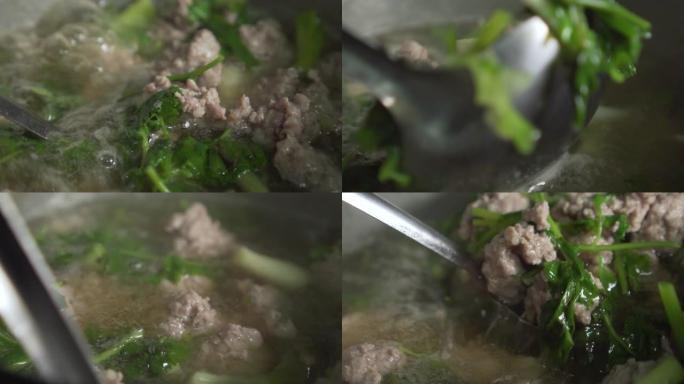 厨师用蔬菜搅拌猪肉汤。慢动作。开水。