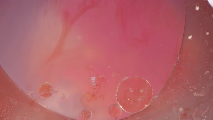 宏观粉色和橙色液体果冻气泡运动纹理背景