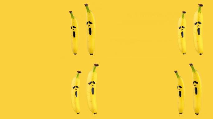 两个香蕉的无缝循环动画，上面画着黄色背景上可怕的恐惧面具。复制空间的万圣节概念