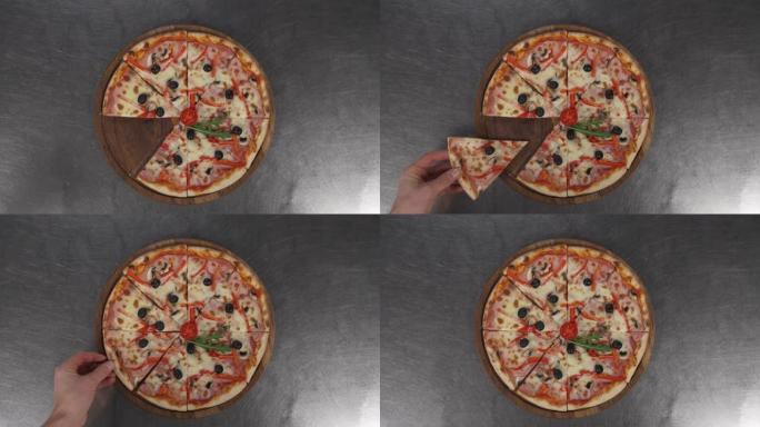 一只手的特写镜头，将缺少的切片放在刚出炉的比萨饼上。披萨的特写镜头，奶酪，西红柿和火腿以及桌子。美味