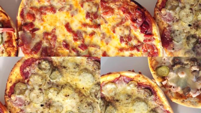 将热比萨饼与奶酪香肠西红柿，传统意大利食品，垃圾食品一起关闭。火腿披萨顶视图