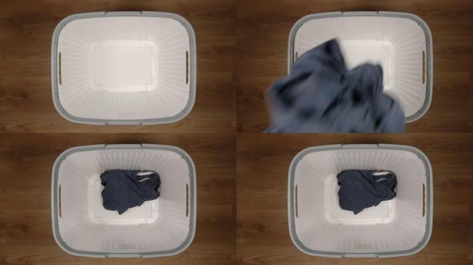 俯视图: 一块脏布掉到洗衣篮上-慢动作