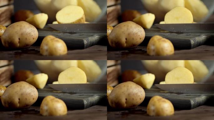 用刀将新鲜土豆切成两半。