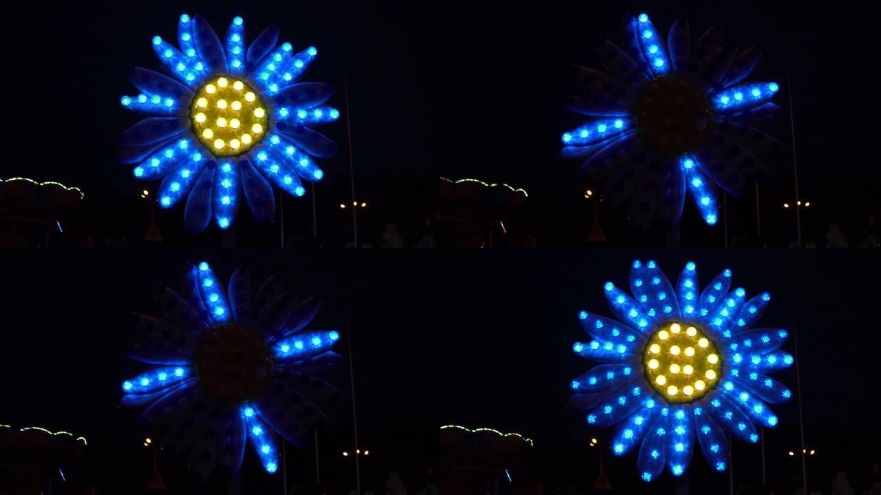 公园里的一朵花在夜晚用五颜六色的灯发光